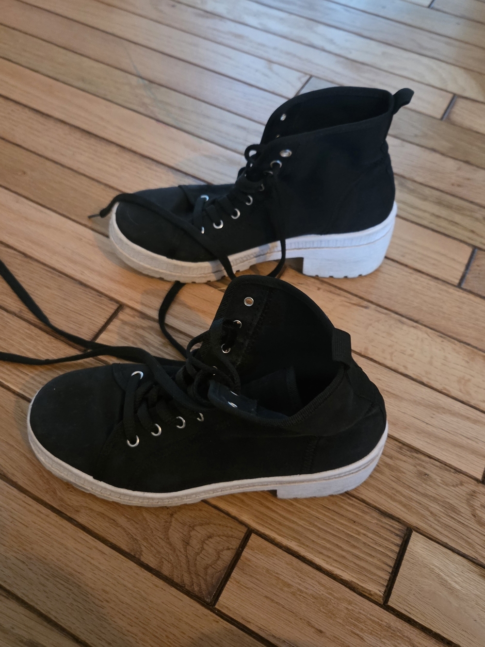 Black high-top fashion sneakers with white soles